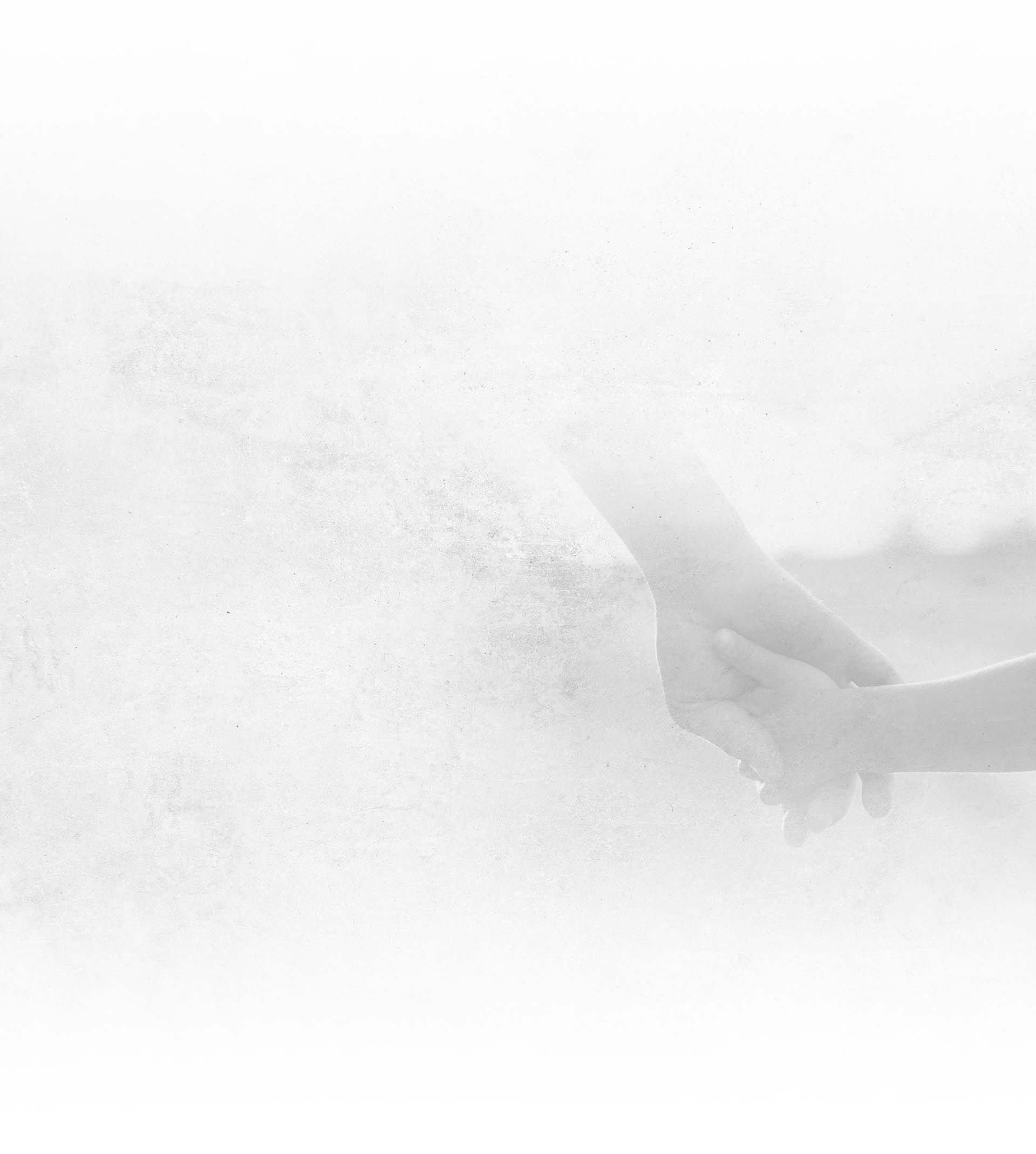 Two hands gently holding each other against a soft, white textured background symbolizing care and support.