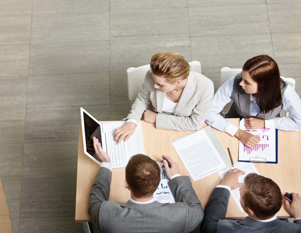 A professional team conducting a business meeting at a table.