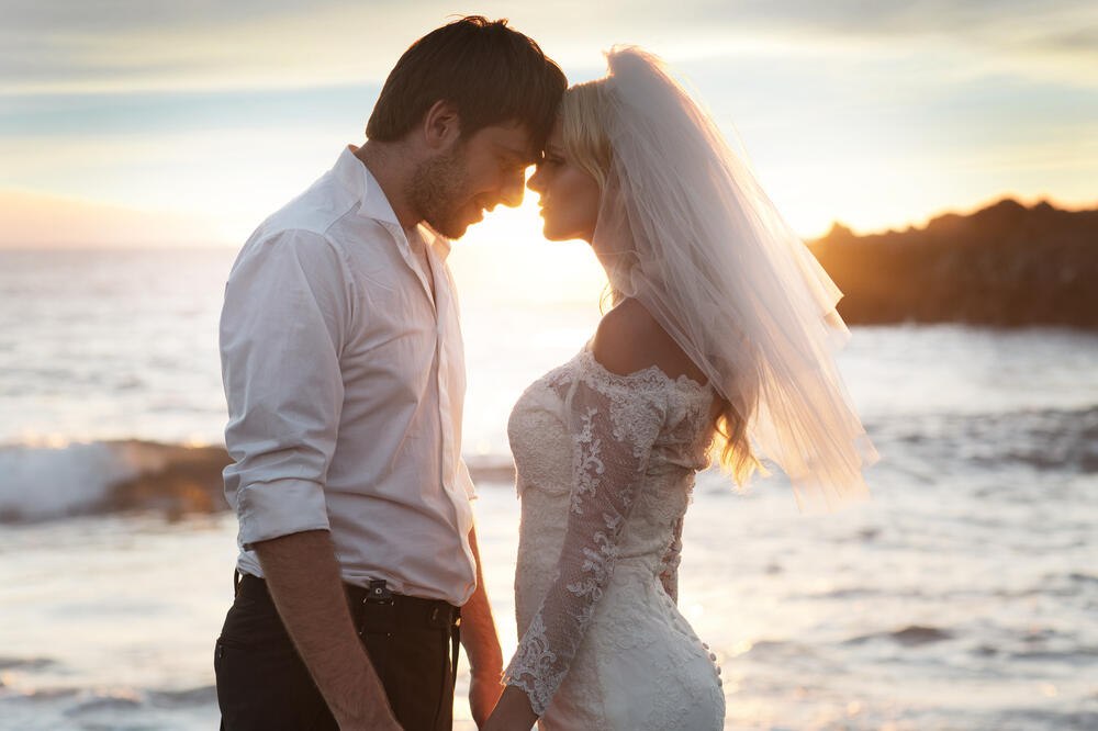 Romantic sunset beach wedding portrait